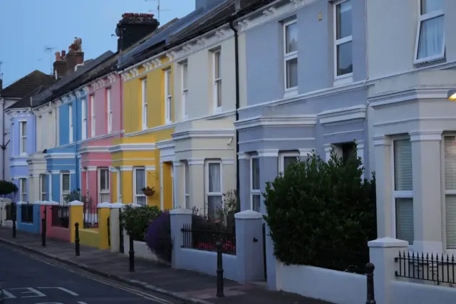 A line of colorful residential homes.