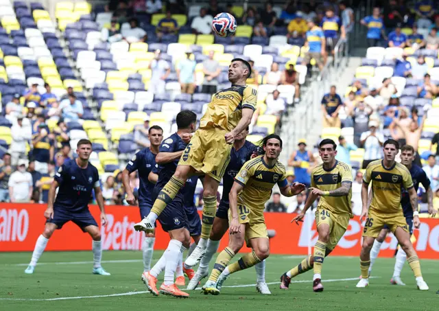 Auckland and Boca Junior players fight for the ball