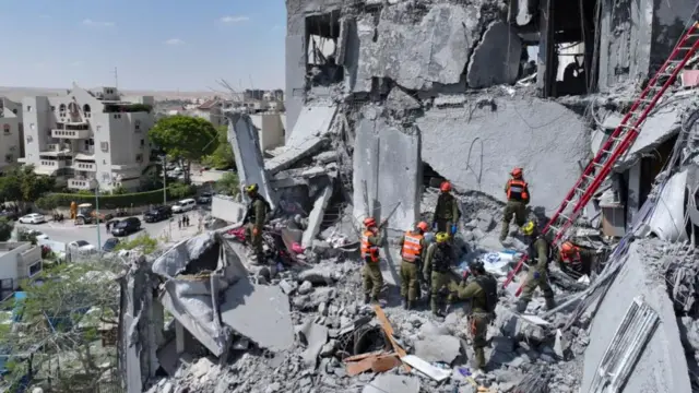 A drone view shows emergency personnel working at an impacted residential site