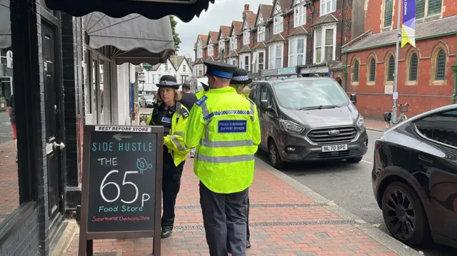 Police approach a shop