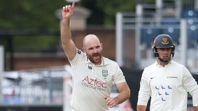 Ben Raine celebrates taking a wicket against Sussex