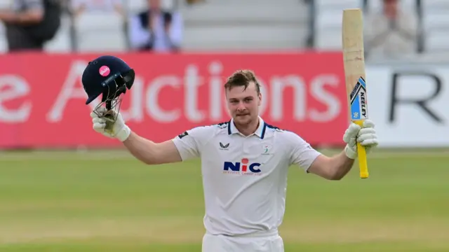 Finlay Bean celebrates after reaching three figures