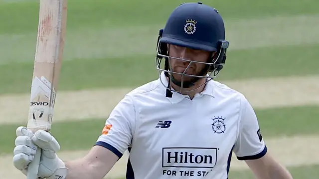 Liam Dawson celebrates scoring century