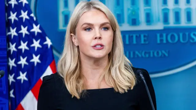 A file photo of White House Press Secretary Karoline Leavitt. She is standing at a microphone with a US flag behind her