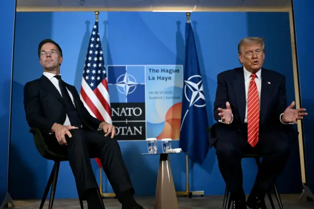 Mark Rutte sitting back on chair while Donald Trump, sat next to him, leans forward and gestures with his hands as he speaks