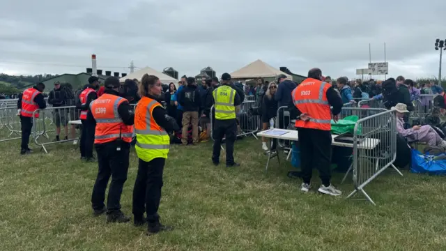 Security guards at the front of Glastonbury queue, before festival goers were let through the gates