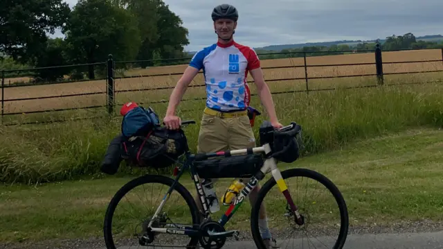 Jack on his bike on the side of the road