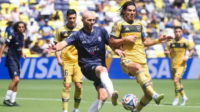 Auckland City's Christian Gray battles for possession with Edinson Cavani of Boca Juniors