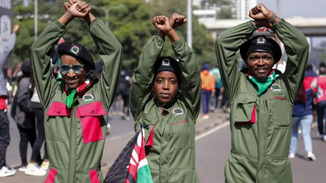 Uniformed protesters carrying Kenyan flags