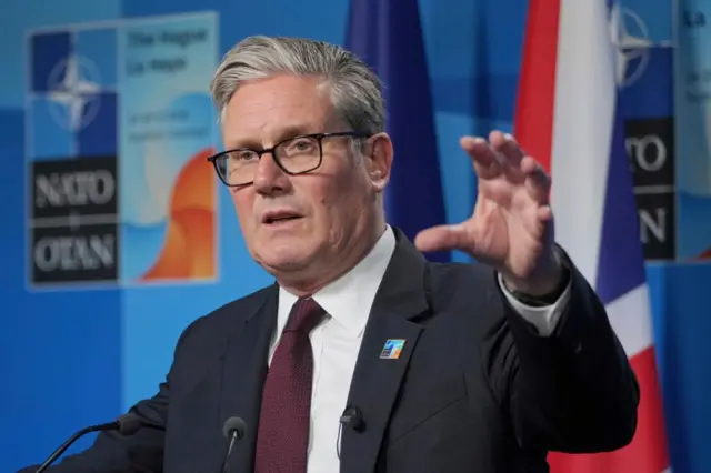 UK Prime Minister Keir Starmer gestures with his hand while speaking at a news conference at a Nato summit