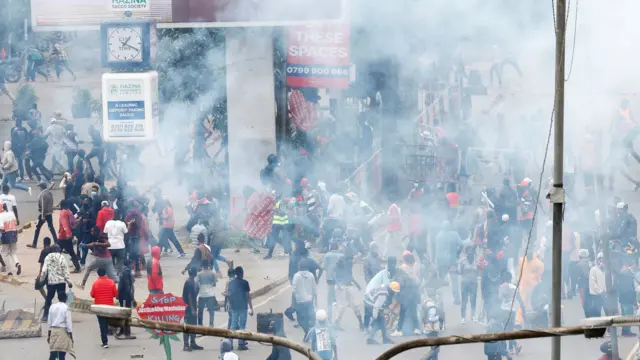 Smoke rises as protestors participate in a demonstration to mark the first anniversary of the 2024 anti-government protests