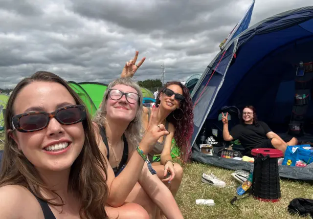 Eden, Chloe, Lauren and Lucy sat outside their tent
