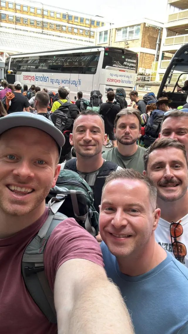 A group stood in front of a coach