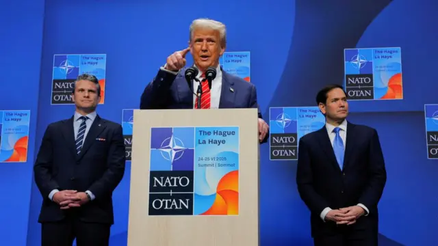 U.S. President Donald Trump speaks at a press conference, as Secretary of Defense Pete Hegseth and Secretary of State Marco Rubio stand behind him