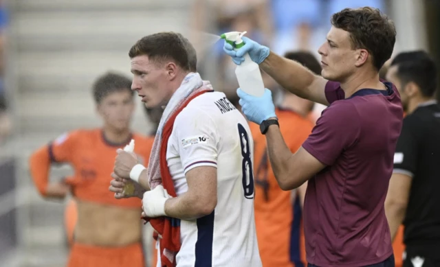 England's Elliot Anderson is cooled down by coach during break in play