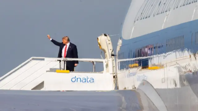 US President Donald Trump waves before boarding the Air Force One from Schiphol Airport, The Netherlands, 25 June 2025, after attending the NATO summit.