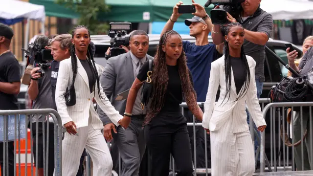 (L-R) D'Lila Combs, Chance Combs and Jessie Combs, the children of US rapper and record executive Sean 'Diddy' Combs, arrive at court with several photographers behind them