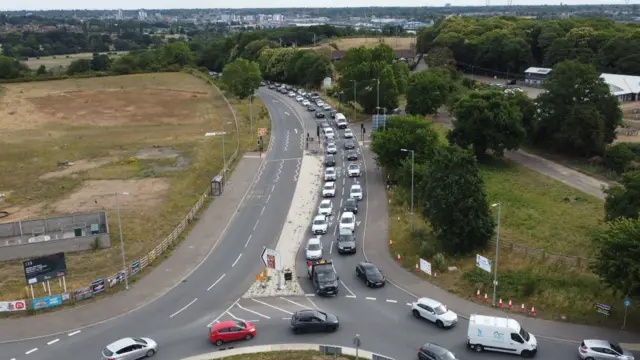 A drone image of queues of traffic on the approach to a roundabout