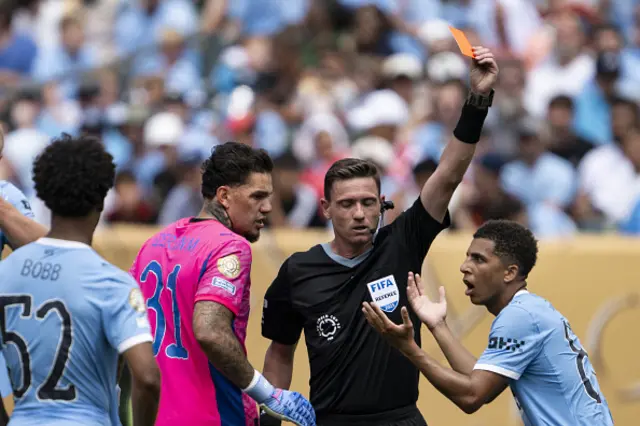 Rico Lewis of Manchester City reacts after getting a red card