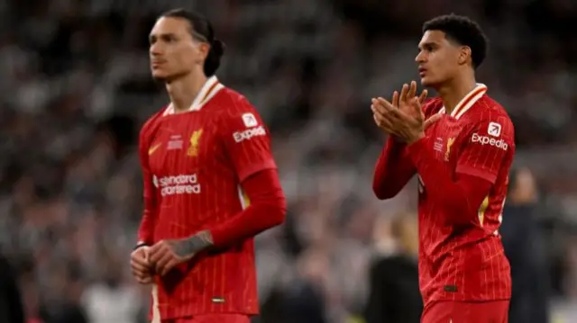 Darwin Nunez of Liverpool looks dejected as teammate Jarell Quansah acknowledges the fans