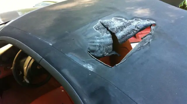 A hole burned into the roof of a Porsche