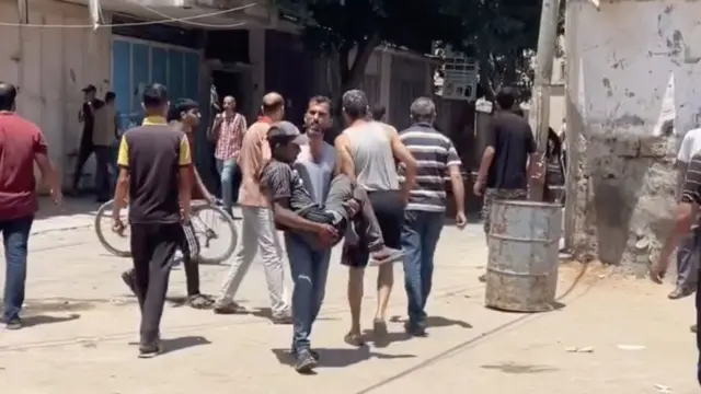 A screengrab from one of the videos shows an injured man being carried from the scene