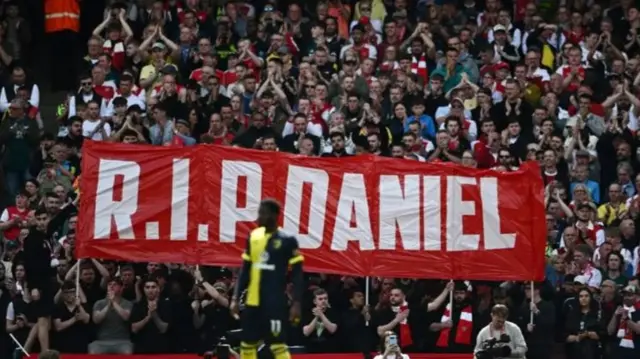 A banner reading 'RIP Daniel' was held among the crowd at Arsenal's football match against Bournemouth