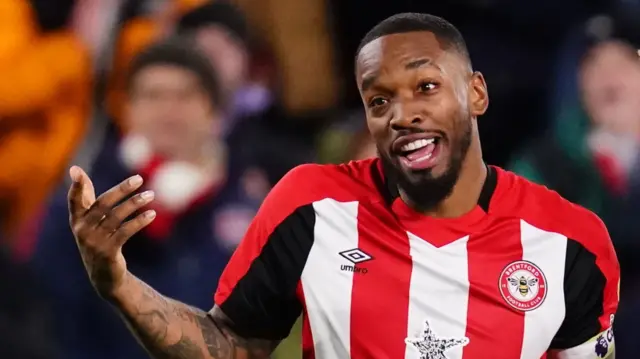 Ivan Toney smiles while playing for Brentford
