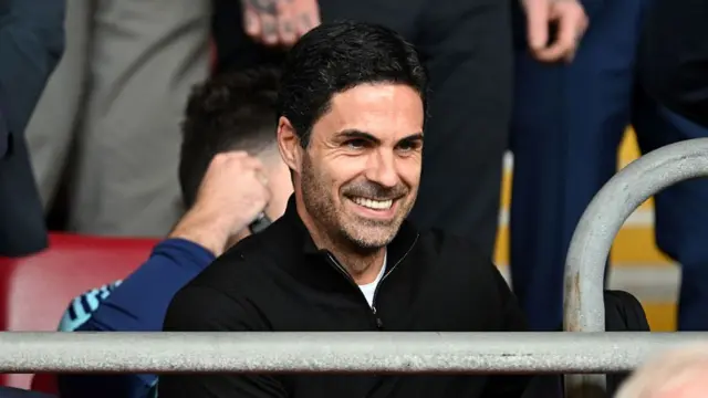Mikel Arteta, Manager of Arsenal, looks on from the stands