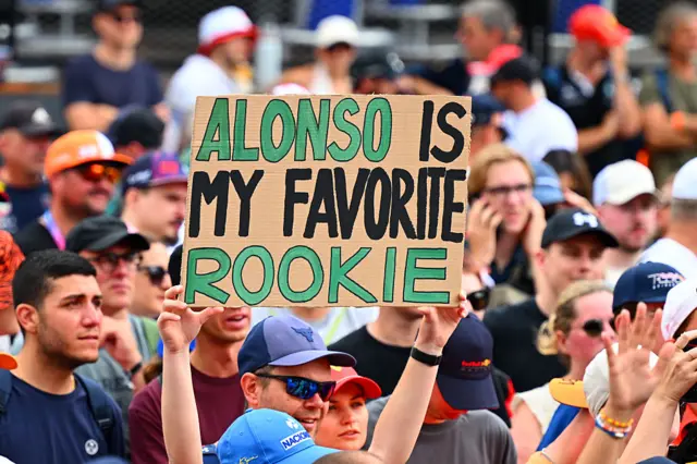 A sign holds up a sign for Alonso