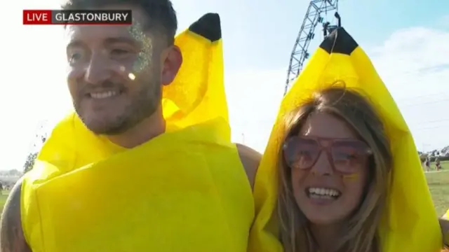Dan and Kate smile at the camera in banana costumes