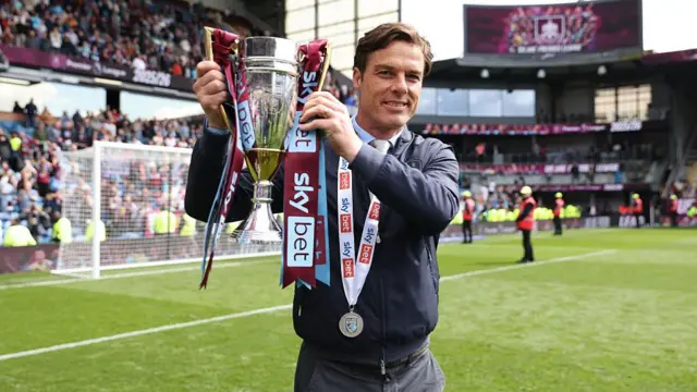 Scott Parker, Manager of Burnley, poses for a photo with the Championship runners up trophy,