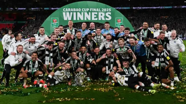Newcastle United's players celebrate with the League Cup trophy