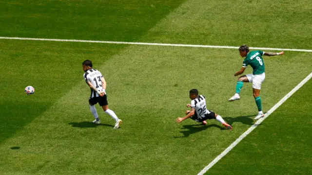 Rios fires at goal from the edge of the box as a defender slides to block