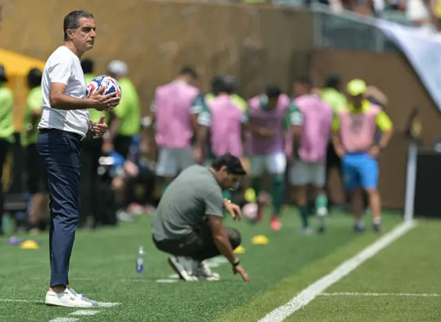 The two managers stand in their technical areas