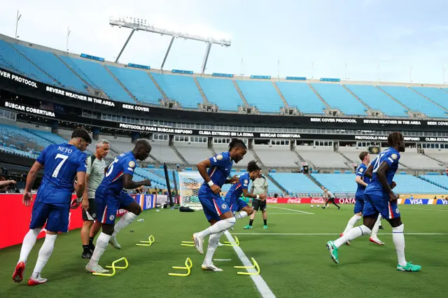 Chelsea players warm-up prior to the game restarting in North Carolina