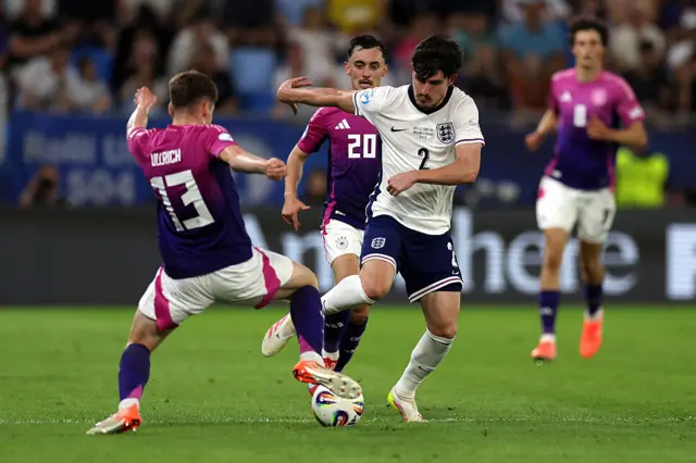 Livramento tries to tackle a German winger