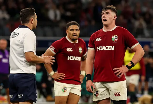 Referee Ben O'Keeffe speaks to British & Irish Lions captain Dan Sheehan