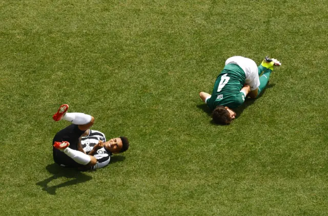 Jesus and Giay lie stricken on the floor after colliding during a challenge