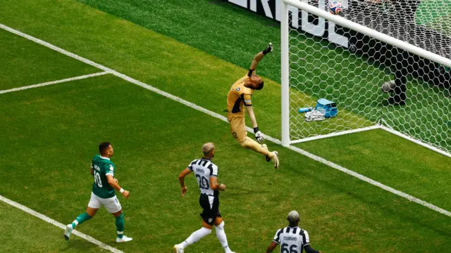John tips a header over the bar at the front post