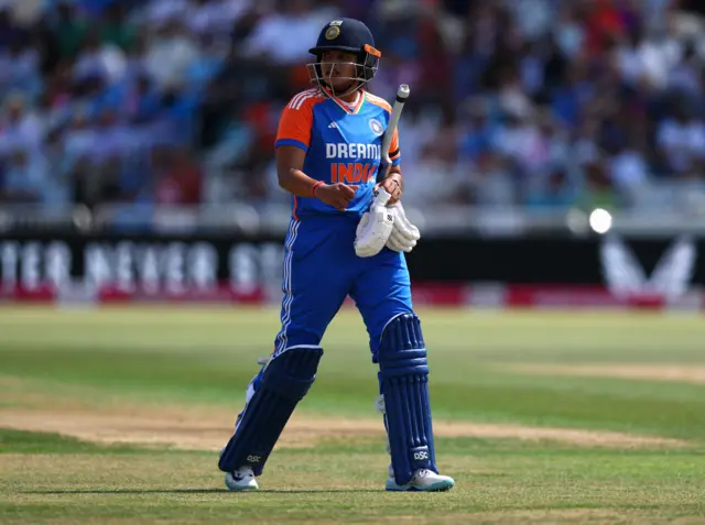 India's Shafali Verma walks off after being caught out by England's Sophie Ecclestone off the bowling of England's Em Arlott