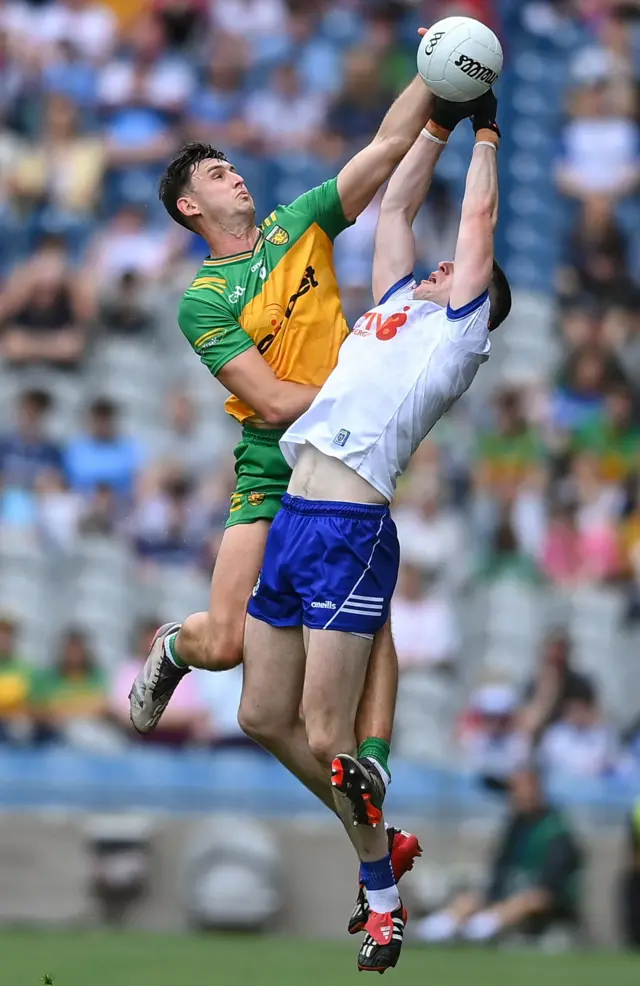 Micheal McCarville of Monaghan in action against Michael Langan of Donegal