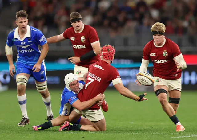 Josh Van Der Flier of the British Irish Lions passes the ball to Henry Pollock