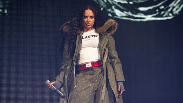 Jade wearing a thick parka on the Glastonbury stage