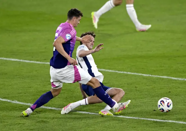 Morton slides into a challenge on the edge of his own box
