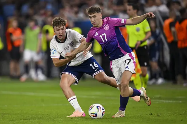 Gruda dribbles past clubmate Hinshelwood on the wing