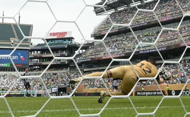 John palms away a shot - behind goal view