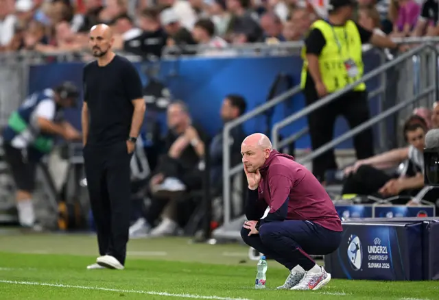 Carsley crouches in his technical area