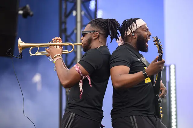 Ife Ogunjobi plays the trumpet and TJ Koleoso rocks the electric guitar back to back on the stage