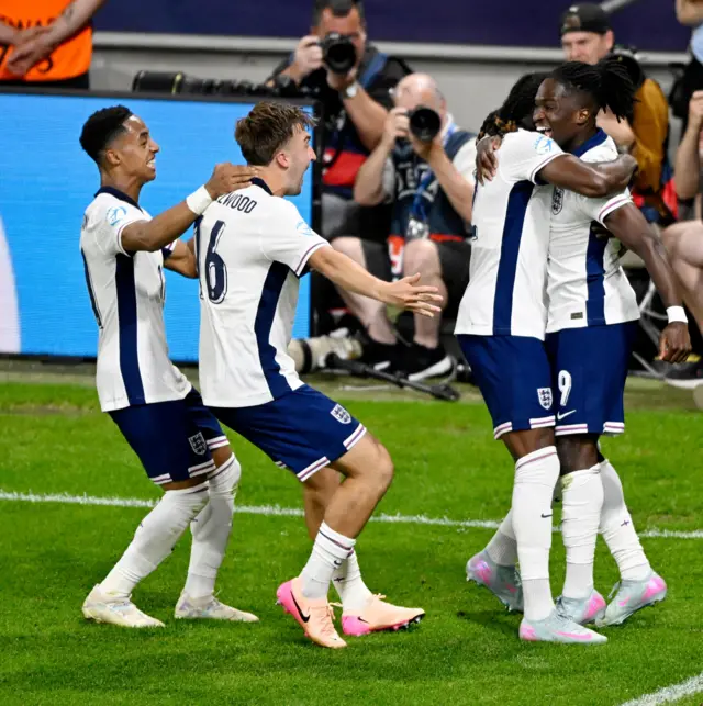 Rowe is mobbed by teammates after putting England ahead